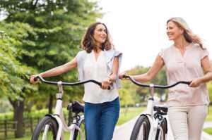 Women talk while going for a bike ride.